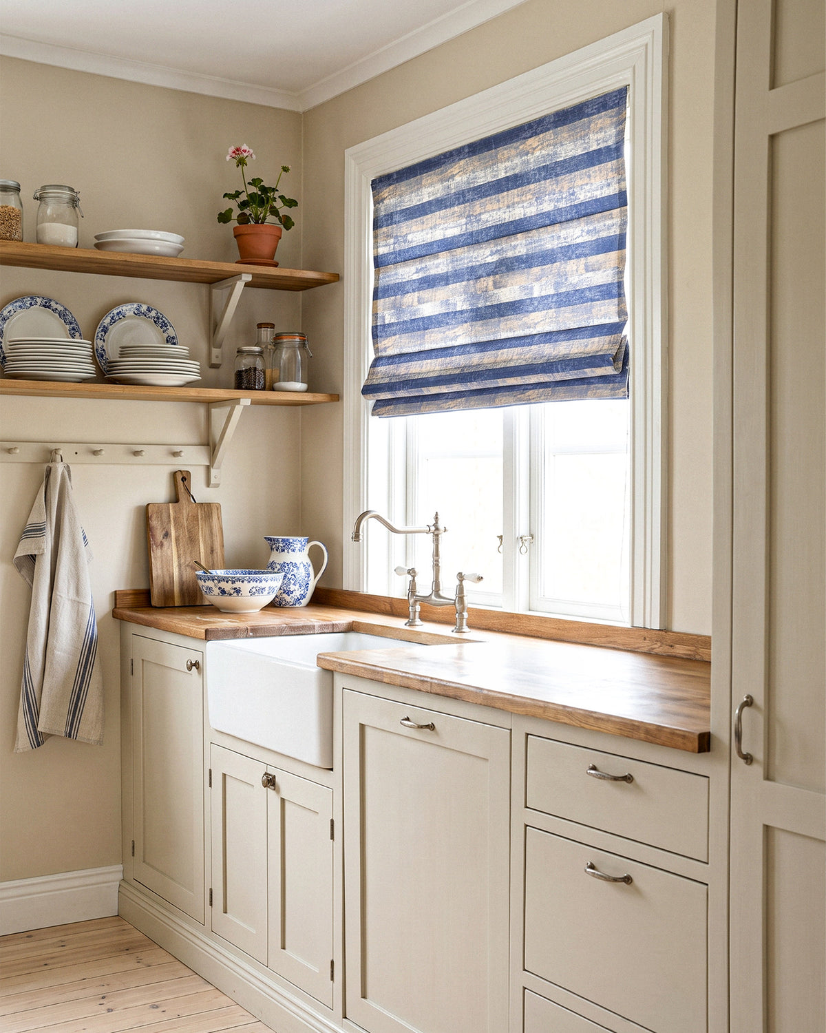 Roman blind in a striped pattern fitted in a country-style kitchen
